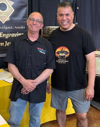 Ron Vallejo of Reflections of Chicagoland Drum Co. with drum engraver John Aldridge at a drum show