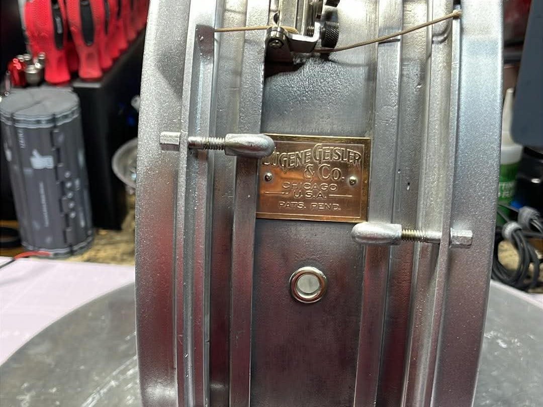Eugene Geisler and Co. Chicago cast aluminum snare drum on the workbench with brass badge