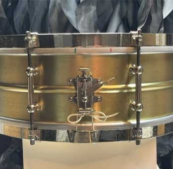Close view of the strainer side after restoration, showing the side-throw strainer and hand-tied snare cord
